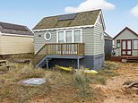 Three-floor timber beach hut in Dorset beauty spot which boasts its own cellar is for sale for £325,000